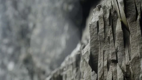 Rocky wall with unique hexagonal pattern in a wet cave in Iceland Stock Footage 253841416