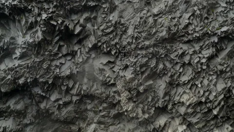 Rocky wall with unique hexagonal pattern in a wet cave in Iceland Stock Footage 253841906
