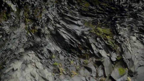 Rocky wall with unique hexagonal pattern in a wet cave in Iceland Stock Footage 253842030