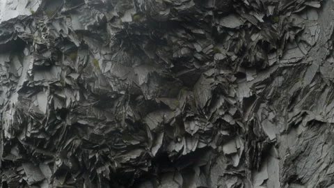 Rocky wall with unique hexagonal pattern in a wet cave in Iceland Stock Footage 253842032