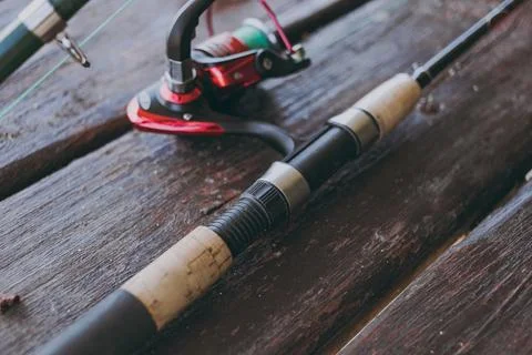 A rod and reel is on the table Stock Photos