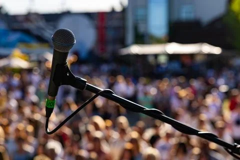 Rofessional vocal microphone close up on live concert stage with blurred cr.. Stock Photos