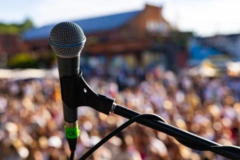 Rofessional vocal microphone close up on live concert stage with blurred cr.. Stock Photos