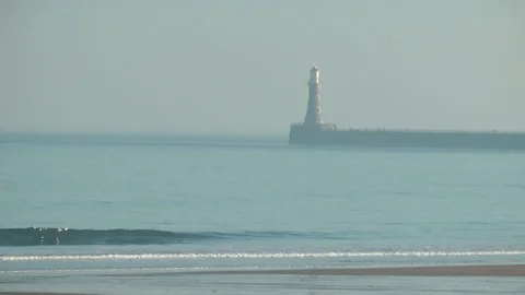 Roker lighthouse from beach Stock Footage 104312216