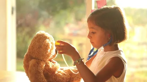 Role playing girl doctor with teddy bear Stock Footage