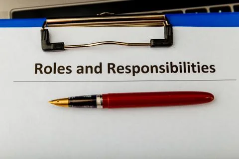 Roles and responcibilities document in the tablet at the desk. Stock Photos