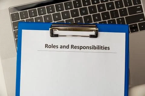 Roles and responcibilities document in the tablet at the desk. Stock Photos