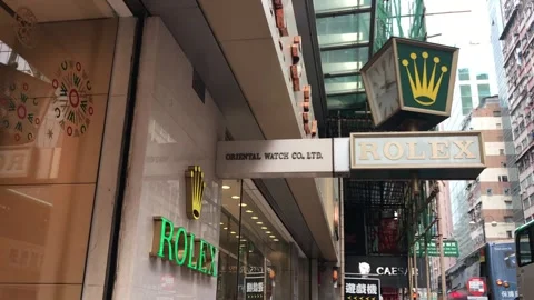 Rolex clock showing different times on building facade Stock Footage 296372556