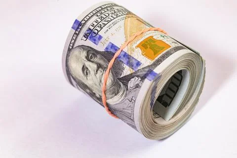 Roll of 100 dollar banknotes on white background Stock Photos