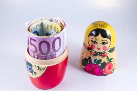 Roll of 50 Euro notes hidden in matryoshka Russian doll. Stock Photos