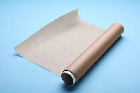 Roll of baking paper on light blue background Stock Photos
