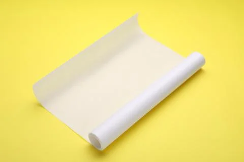 Roll of baking paper on yellow background Stock Photos