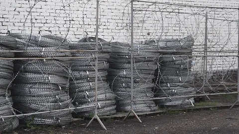 A roll of barbed wire over white background Stock Footage 83796375
