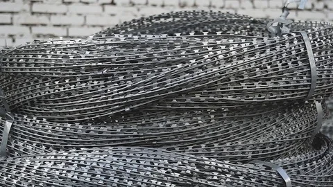A roll of barbed wire over white background Stock Footage 83796437
