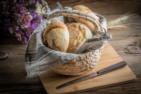 Roll breads in basket on table. Stock Photos