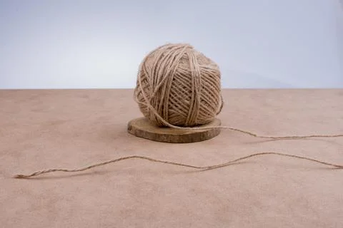 Roll of brown color linen string on brown background Stock Photos