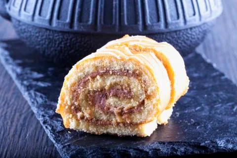 Roll cake with teapot Stock Photos