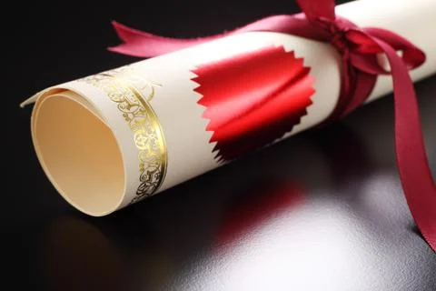 Roll of certificate on the black background Stock Photos