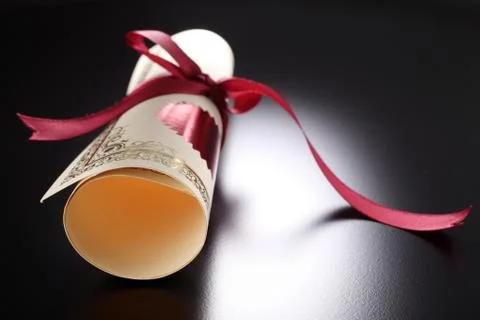 Roll of certificate on the black background Stock Photos