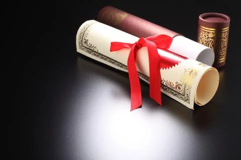 Roll of certificate on the black background 스톡 사진
