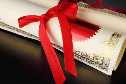 Roll of certificate on the black background Stock Photos
