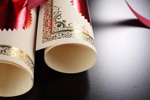 Roll of certificate on the black background Stock Photos