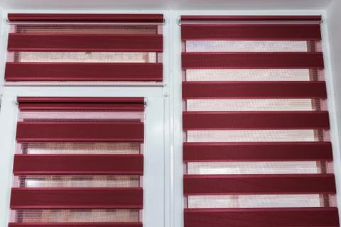 Roll dark red blinds on the windows to protect sunlight and lighting Stock Photos