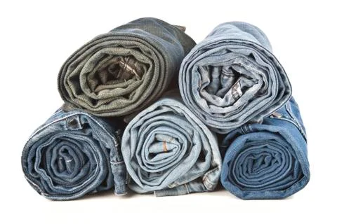 Roll  denim jeans arranged in stack Stock Photos