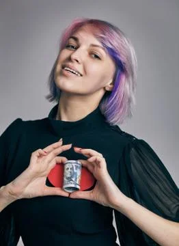 A Roll of dollars with the heart made of two womans hands. love money concept Stock Photos