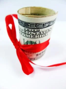 Roll Dollars With red Bow Close Up Stock Photos