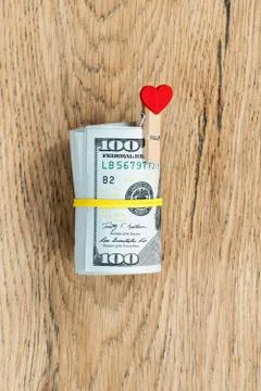 Roll of dollars with yellow rubber Stock Photos