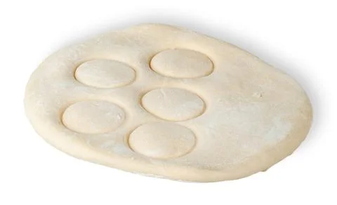 Roll dough with pressed through circles Stock Photos