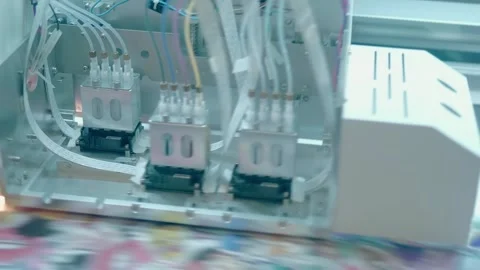 A roll-fed wide-format printer's head applies ink to a huge banner Stock Footage 340632630