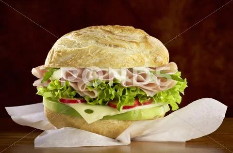 A roll filled with cheese, ham and salad Stock Photos