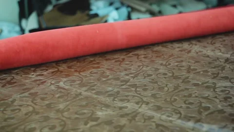 Roll of genuine red leather is spread on the table for processing Vídeos de archivo 100618884