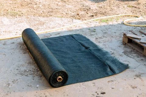 Roll of green shading net, artificial shading of plants or trees from the sun. Stock Photos