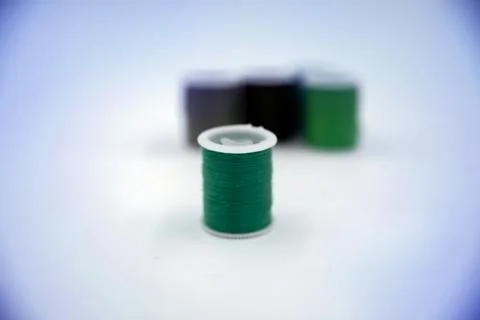 Roll of green thread put on white background,show texture,for needle work,blu 写真素材
