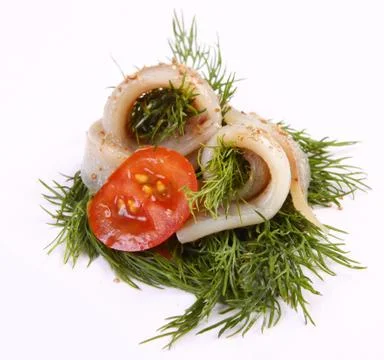 Roll with herring.Herring on pertse.esklyuziv dish of ryby.File capelin. Pres Stock Photos