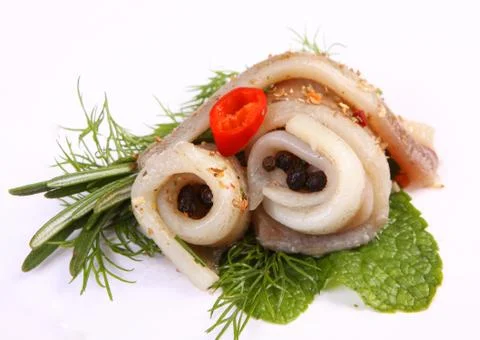 Roll with herring.Herring on pertse.esklyuziv dish of ryby.File capelin. Pres Stock Photos