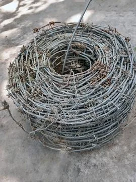 Roll of old barbed wire close up Stock Photos