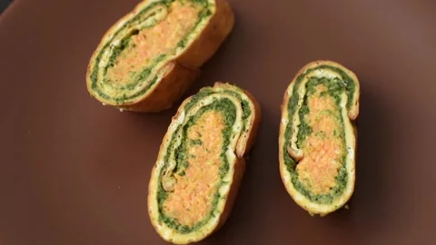 Roll of omelette, spinach, cheese and minced meat Stock Footage 310903573