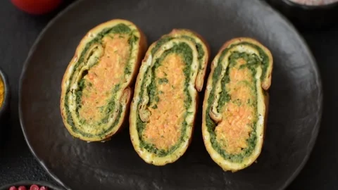 Roll of omelette, spinach, cheese and minced meat Stock Footage 310903589