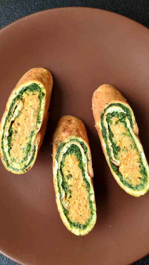 Roll of omelette, spinach, cheese and minced meat Stock Footage 310903667