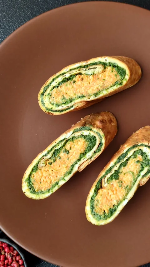 Roll of omelette, spinach, cheese and minced meat Stock Footage 310903670