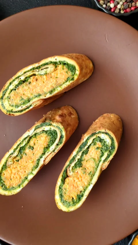 Roll of omelette, spinach, cheese and minced meat Stock Footage 310903672