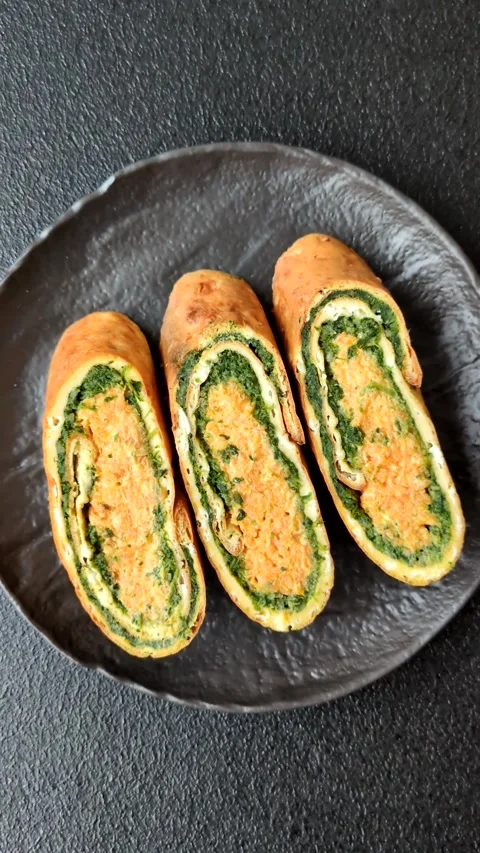 Roll of omelette, spinach, cheese and minced meat Stock Footage 310903675