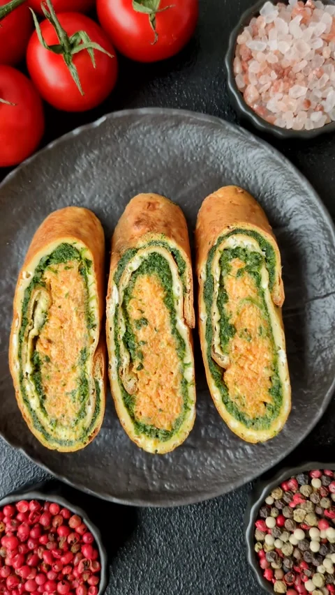 Roll of omelette, spinach, cheese and minced meat Stock Footage 310903679