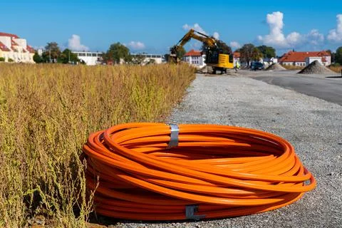Roll of orange cable at construction site. Stock Photos