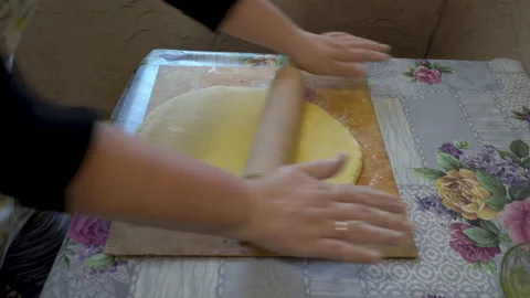 Roll out the dough and put in a baking pan Stock Footage 172430746