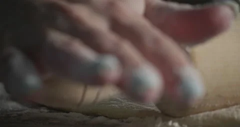 Roll out the dough with a close-up rolling pin Stock Footage 132026884